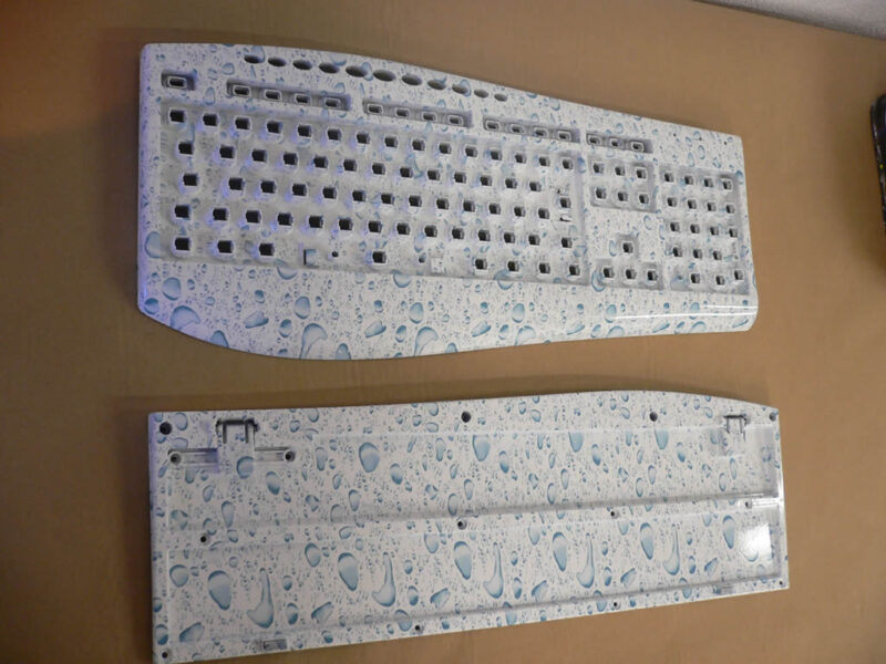 PC Keyboard in water drops over white base