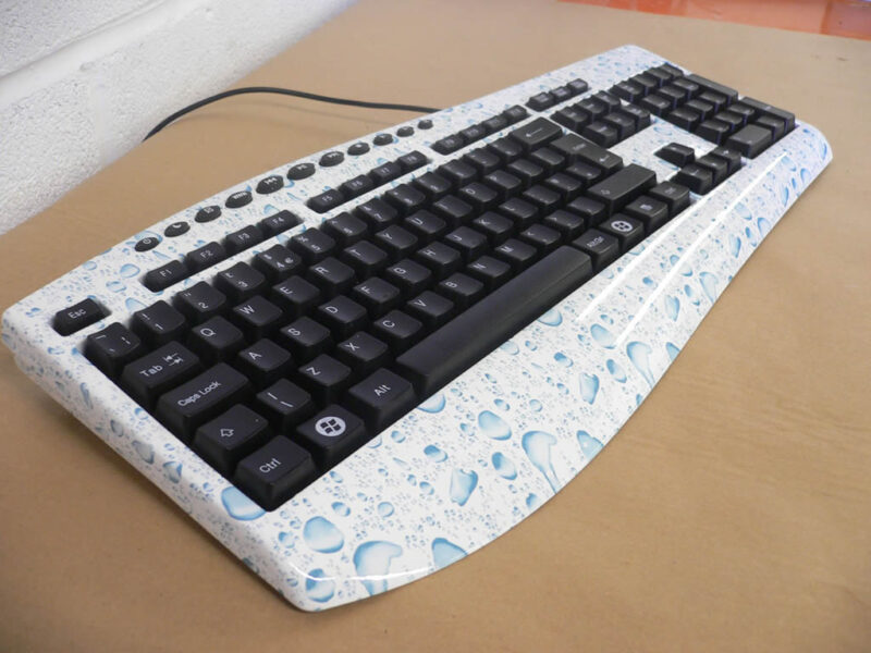 PC Keyboard water drops over white base