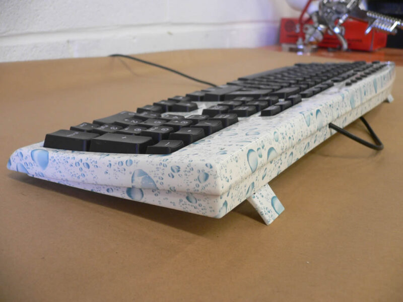 PC Keyboard water drops over white base