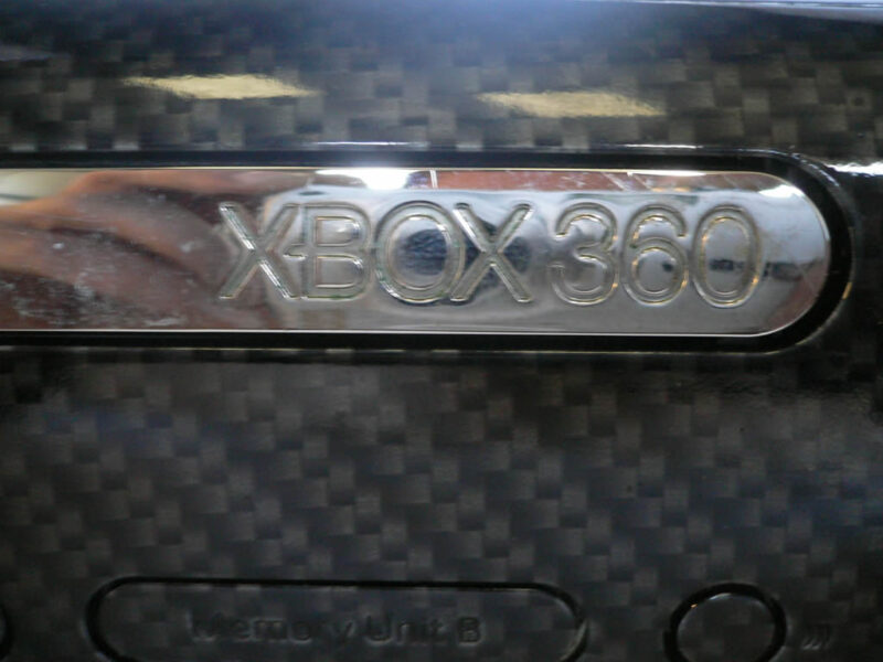 close up carbon dipping on xbox 360 case