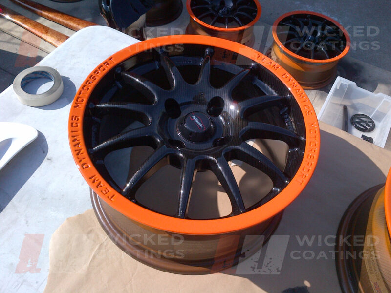 Carbon dipped wheel with bright orange painted rim