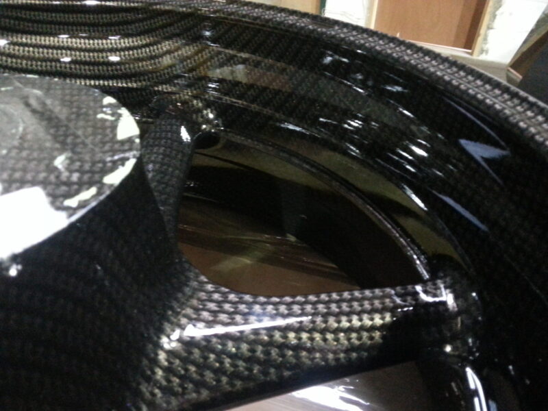 Motorbike alloy wheels coated in carbon fibre painted black
