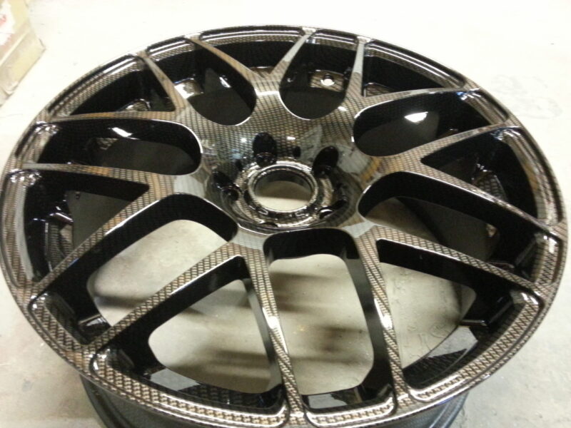 Car alloy wheels coated in carbon fibre