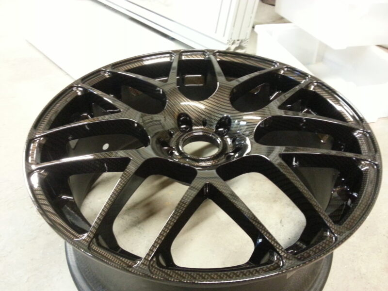 Car alloy wheels coated in carbon fibre