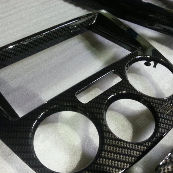 Parts of dashboard coated in carbon fibre