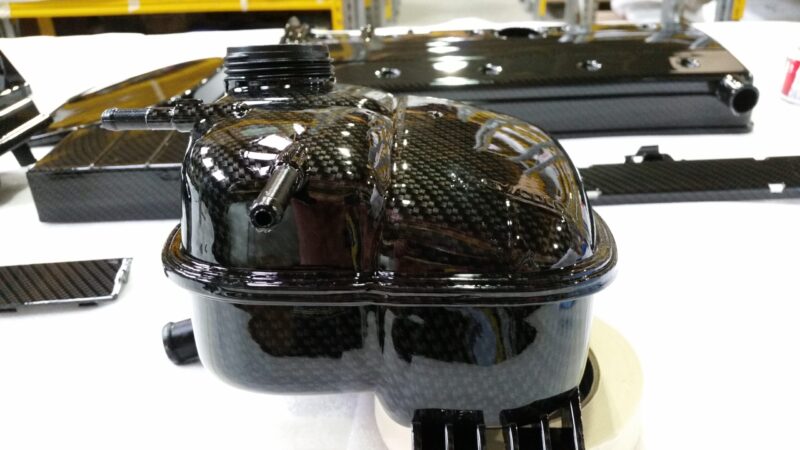 Car engine elements coated in carbon fibre hydrographic film painted black