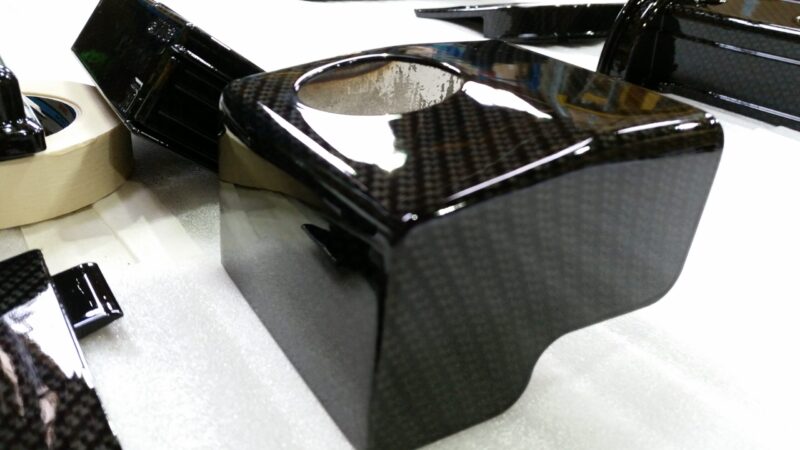 Car engine elements coated in carbon fibre hydrographic film painted black