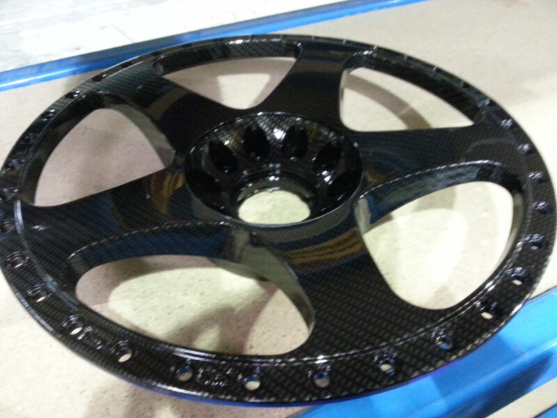 Car alloy wheels coated in carbon fibre hydrographic film painted black