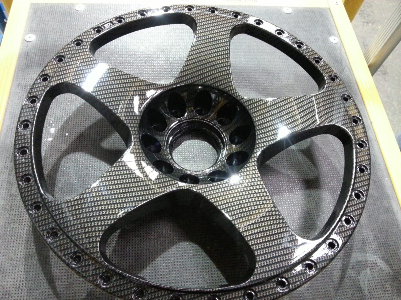 Car alloy wheels coated in carbon fibre hydrographic film painted black