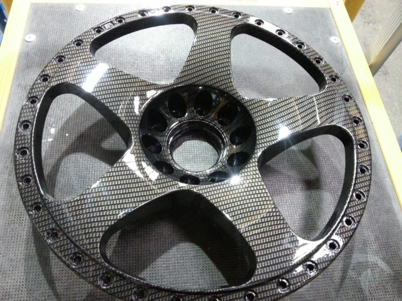 Car alloy wheels coated in carbon fibre hydrographic film painted black