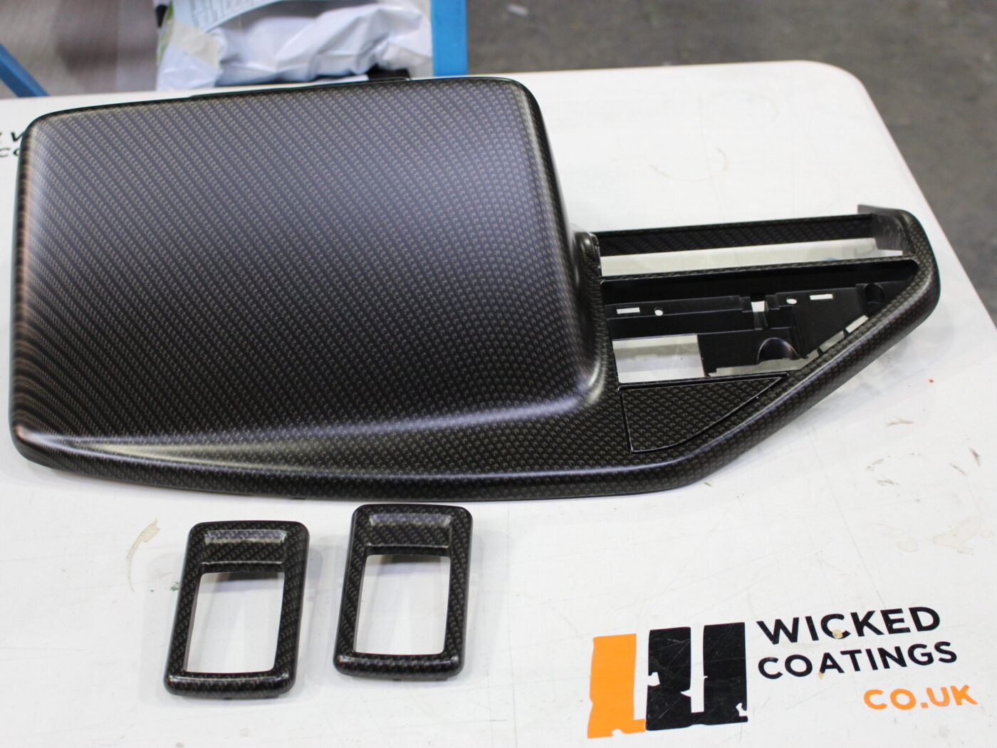 Various car interior parts coated in carbon fibre