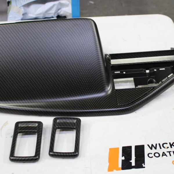 Various car interior parts coated in carbon fibre