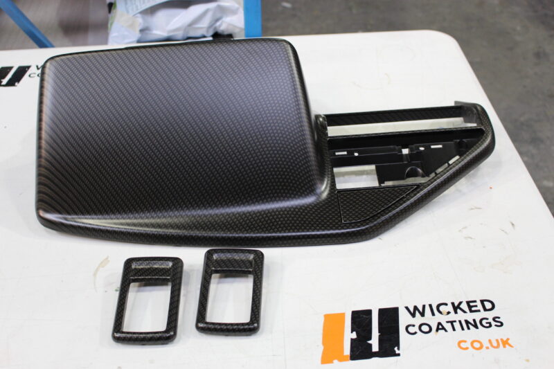 Various car interior parts coated in carbon fibre