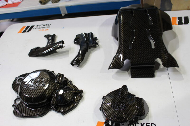Motorbike engine parts coated in Carbon Fibre hydrographic film