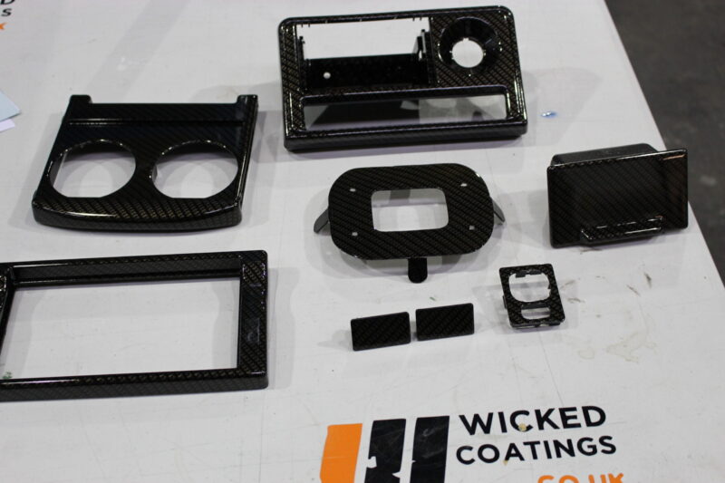 Car dashboard elements coated in carbon fibre
