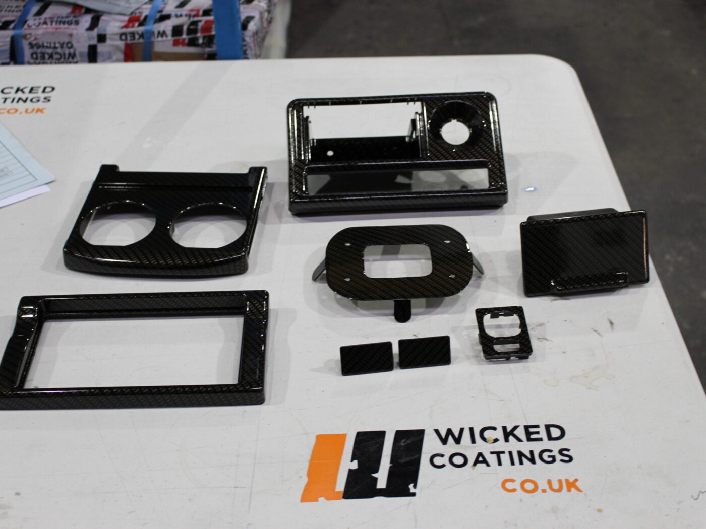 Car dashboard elements coated in carbon fibre