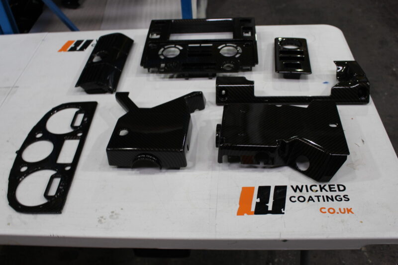Parts of dashboard coated in carbon fibre