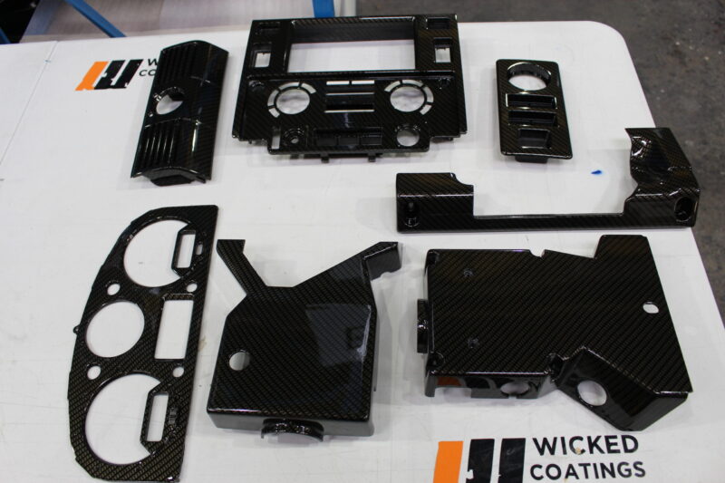 Parts of dashboard coated in carbon fibre