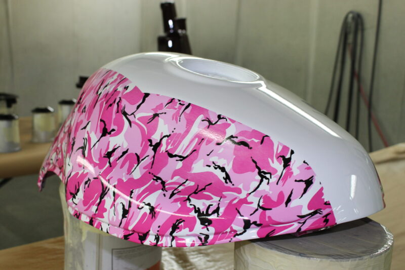 Motorbike tank painted in white, coated in fancy como hydrographic film.