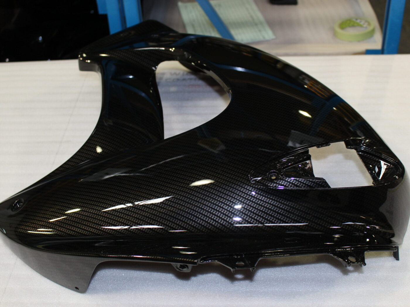 Various motorbike parts coated in carbon fibre