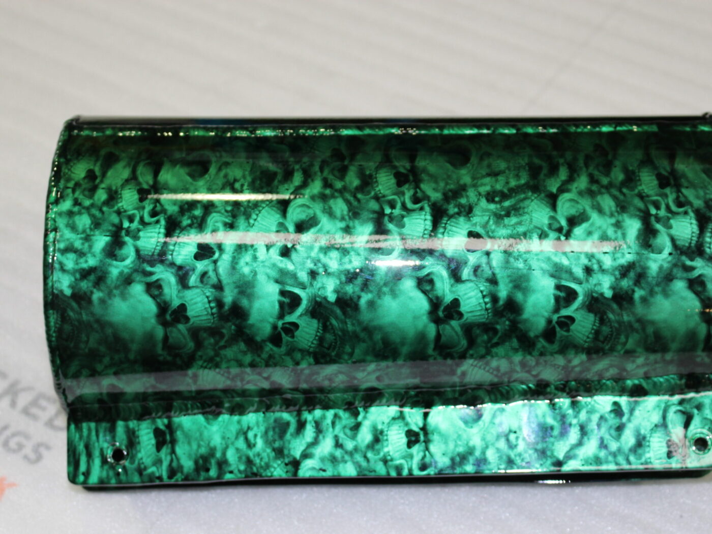 Exhaust coated in skull pattern painted green