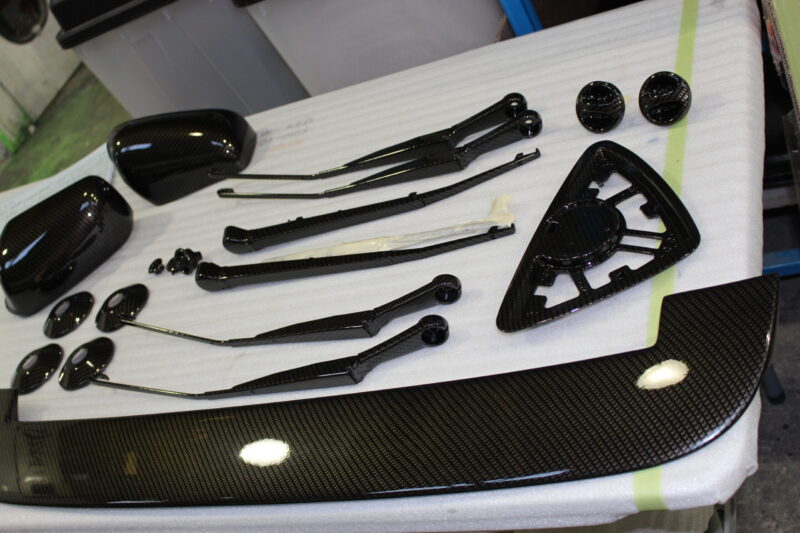 Car exterior element coated in carbon fibre