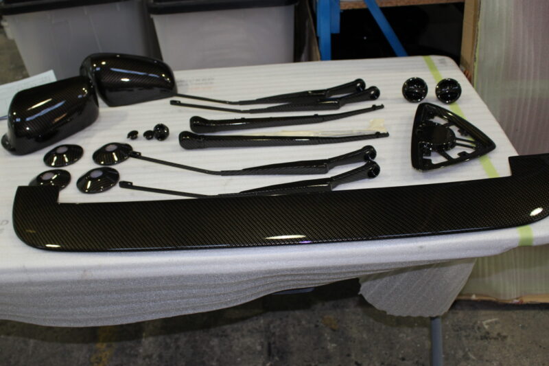 Car exterior element coated in carbon fibre