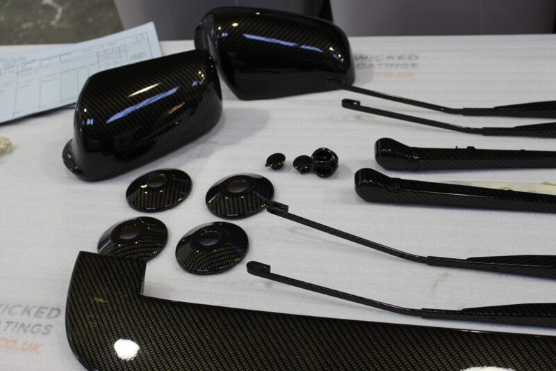 Car exterior element coated in carbon fibre