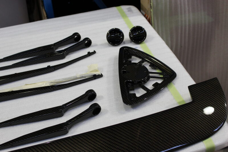 Car exterior element coated in carbon fibre