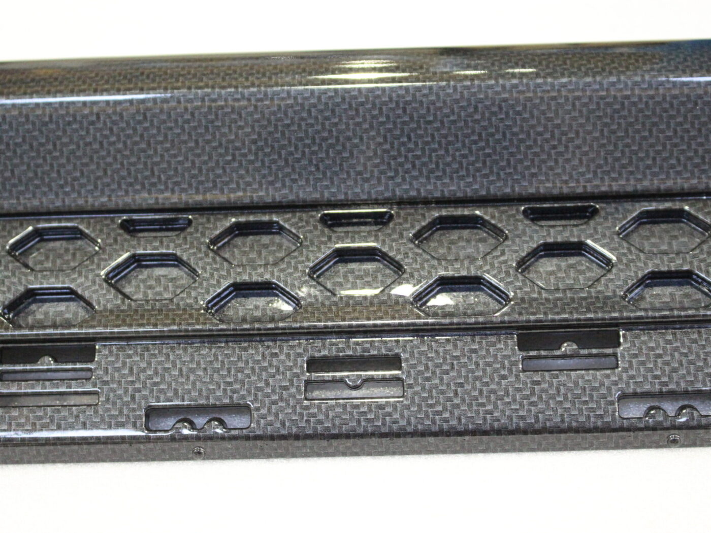 Car interior elements coated in carbon fibre