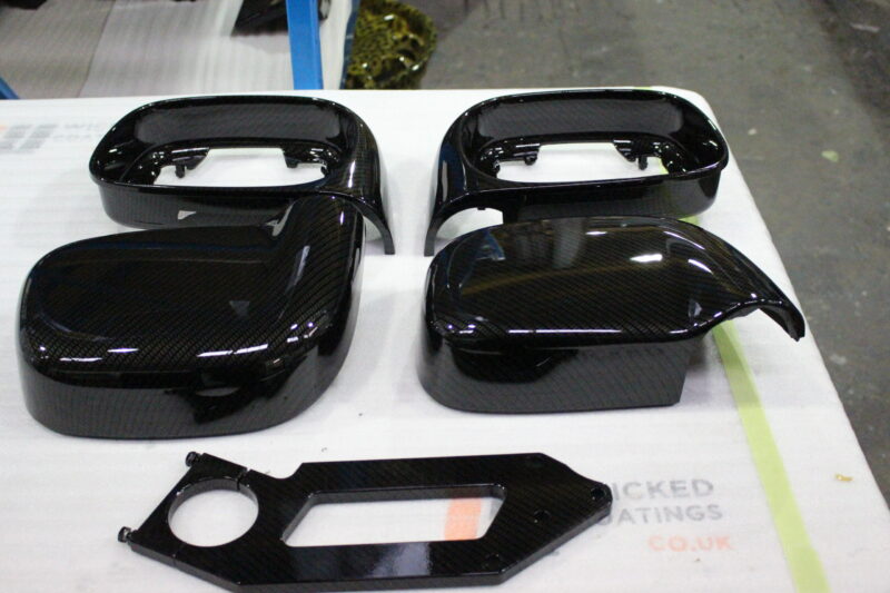 Car mirrors cover coated in carbon fibre