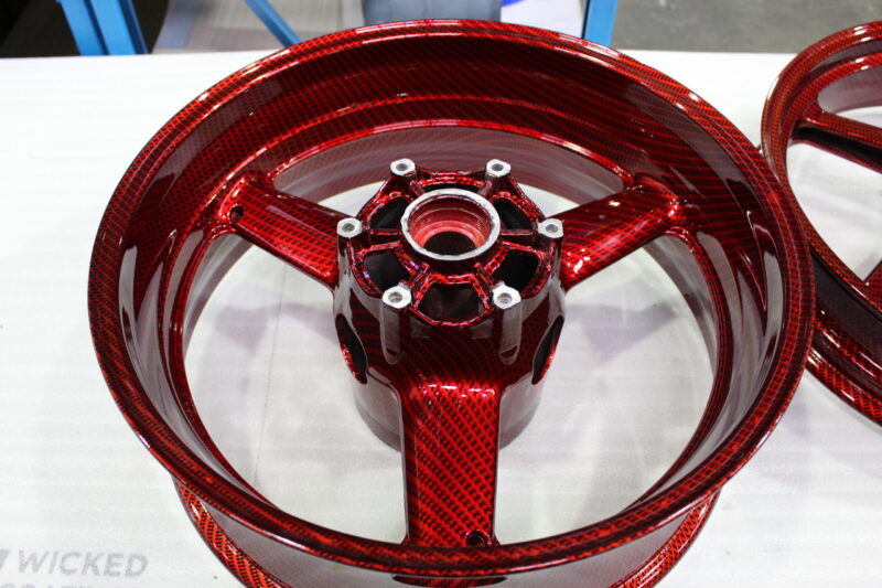 Motorbike alloy wheels coated in carbon fibre painted dark red