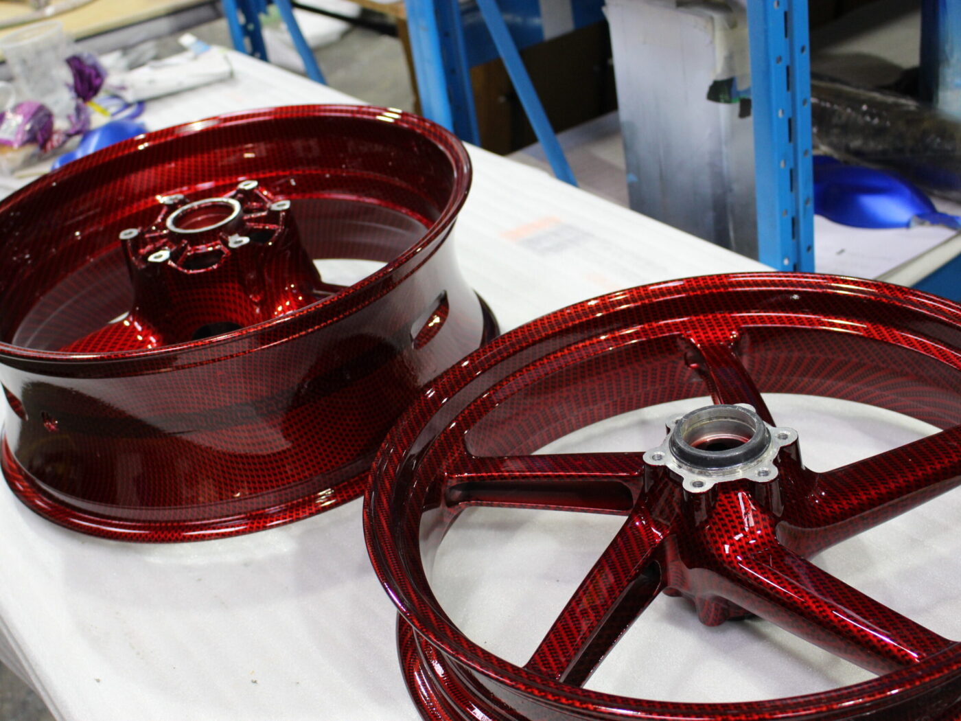Motorbike alloy wheels coated in carbon fibre painted dark red