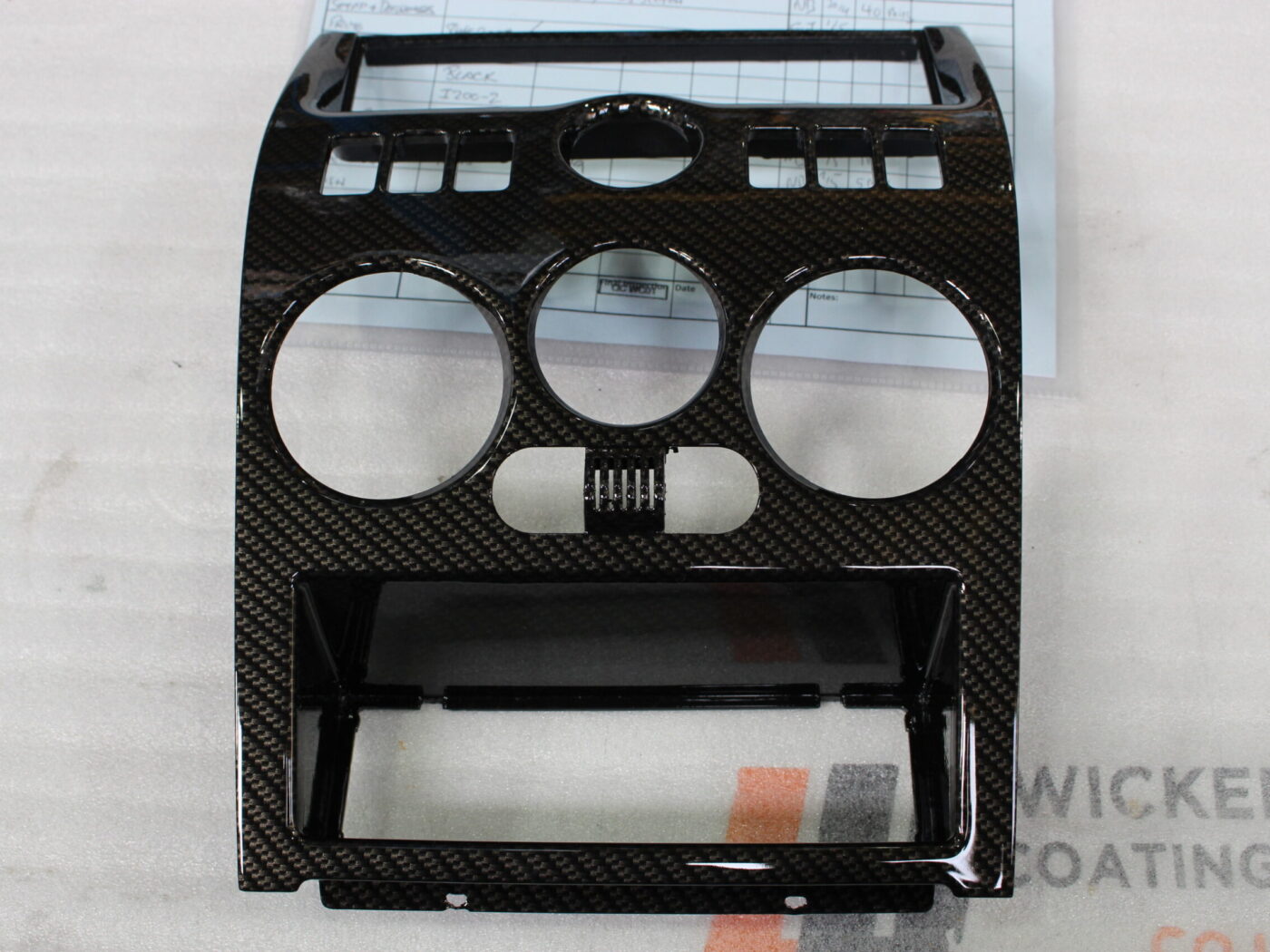 Parts of dashboard coated in carbon fibre