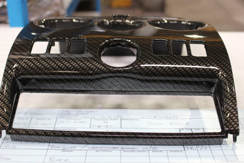 Parts of dashboard coated in carbon fibre