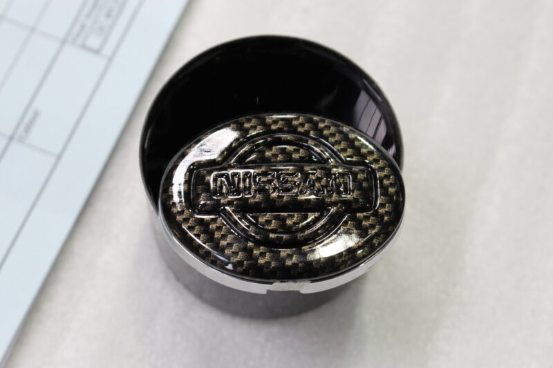 Nissan badge coated in carbon fibre
