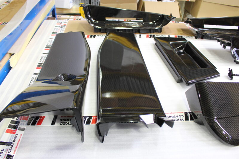 Car interior elements coated in carbon fibre