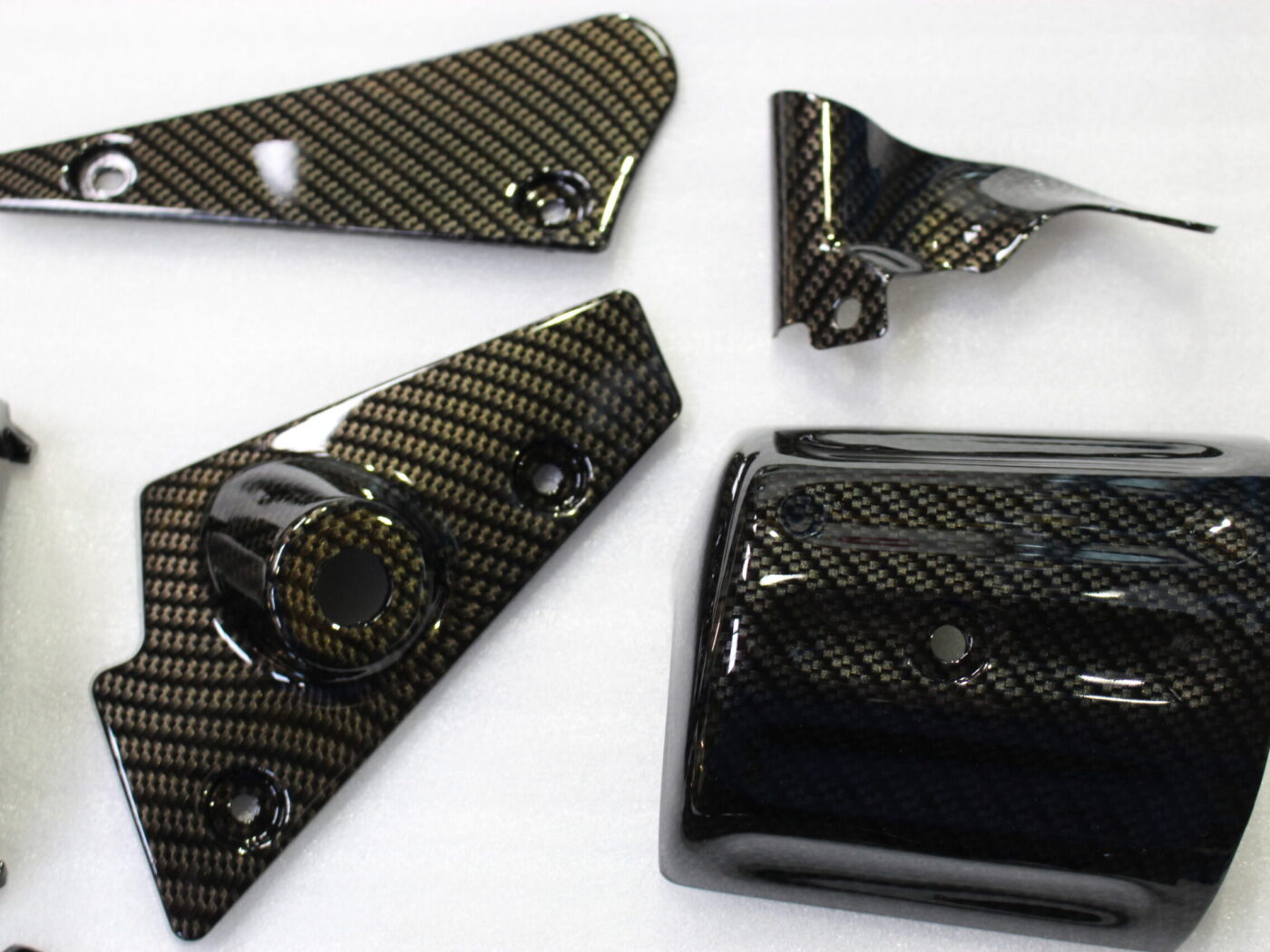 Various car exterior coated in carbon fibre