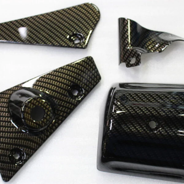 Various car exterior coated in carbon fibre
