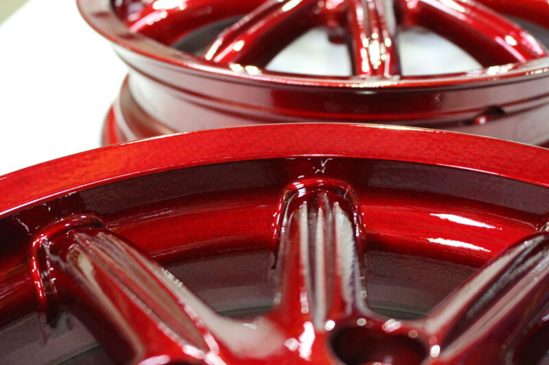 Car alloy wheels coated in carbon fibre painted red