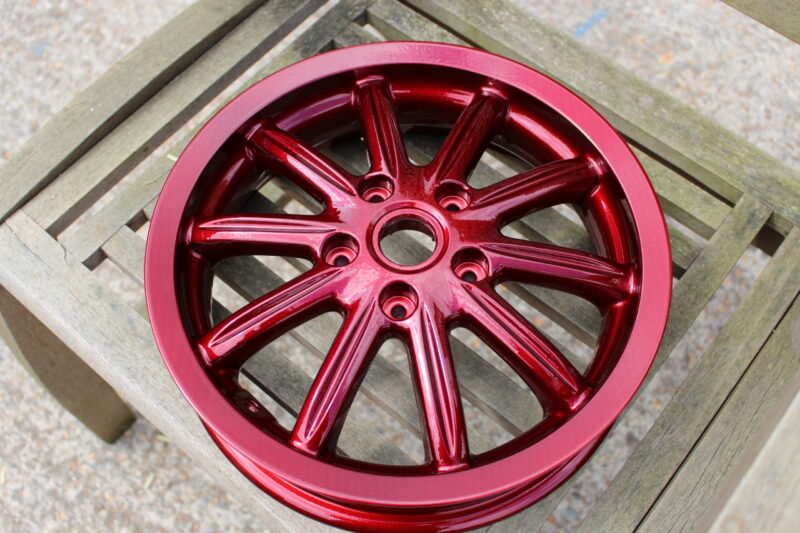 Car alloy wheels coated in carbon fibre painted red