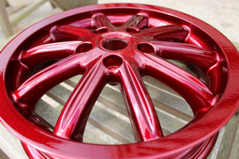 Car alloy wheels coated in carbon fibre painted red