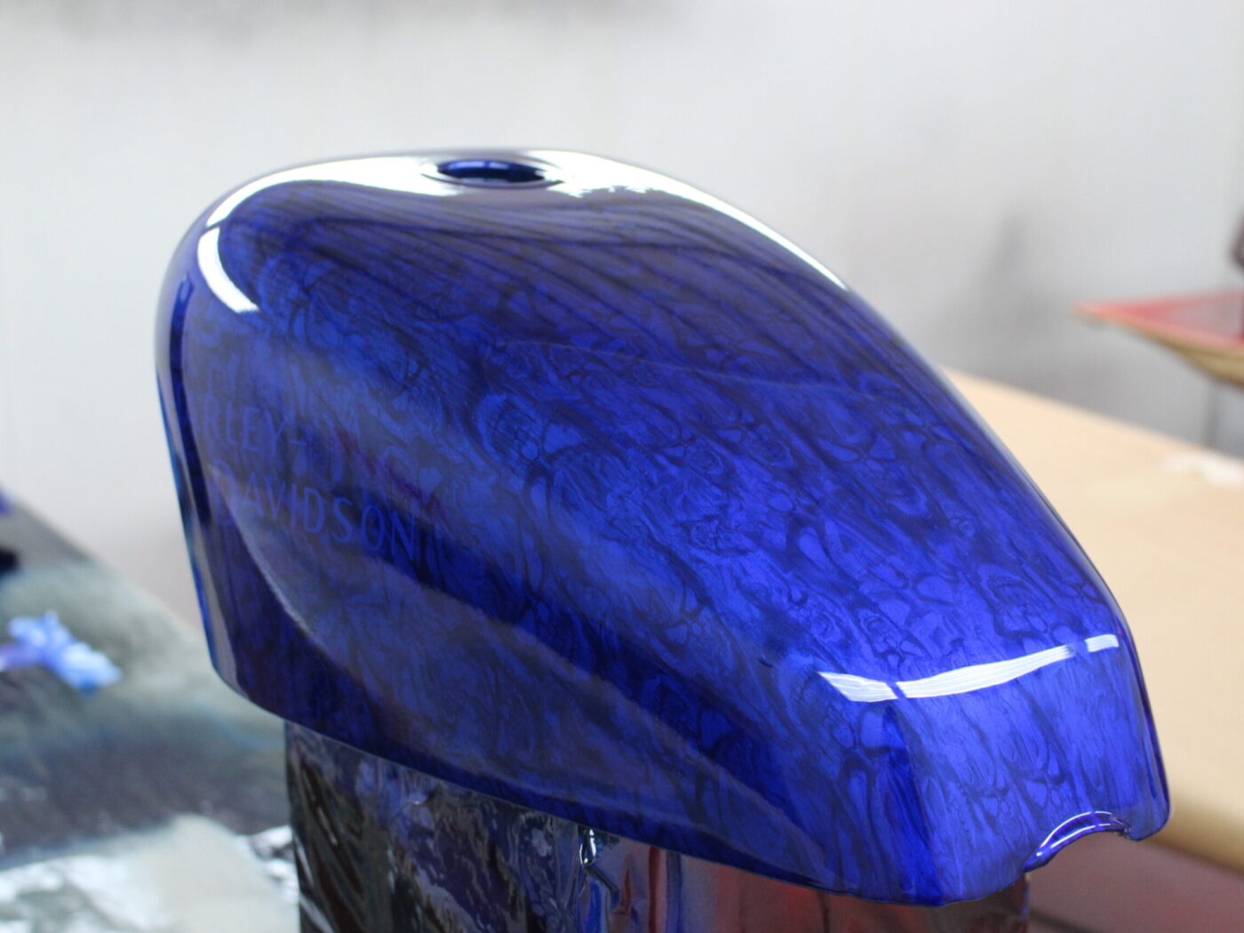 Motorbike tank coated in skull pattern painted blue