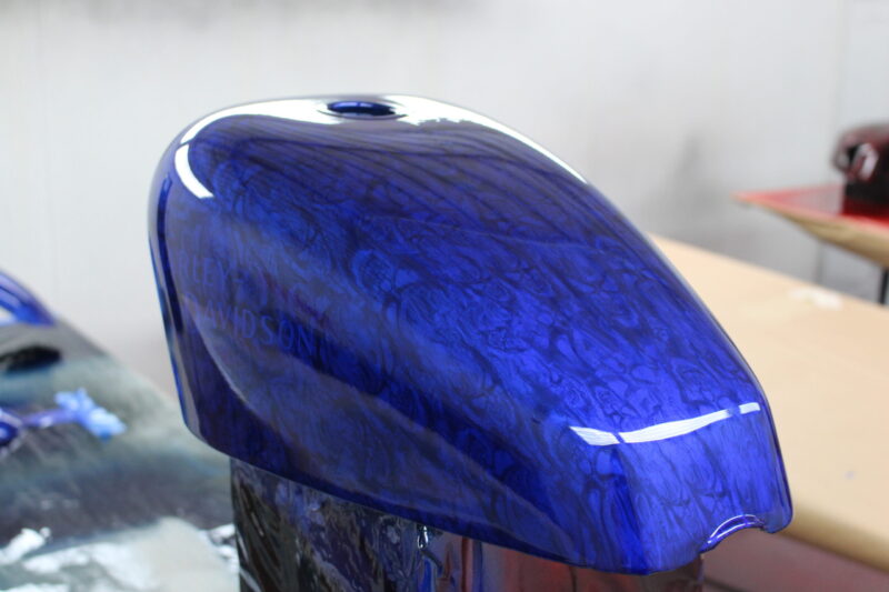 Motorbike tank coated in skull pattern painted blue