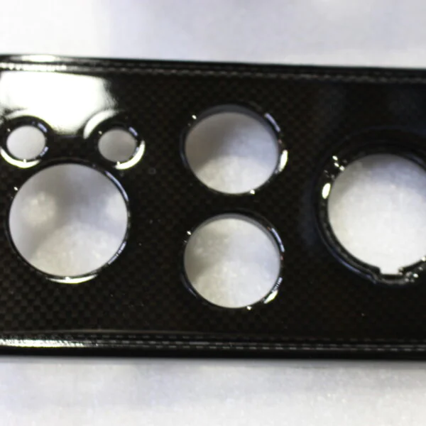 Parts of dashboard coated in carbon fibre
