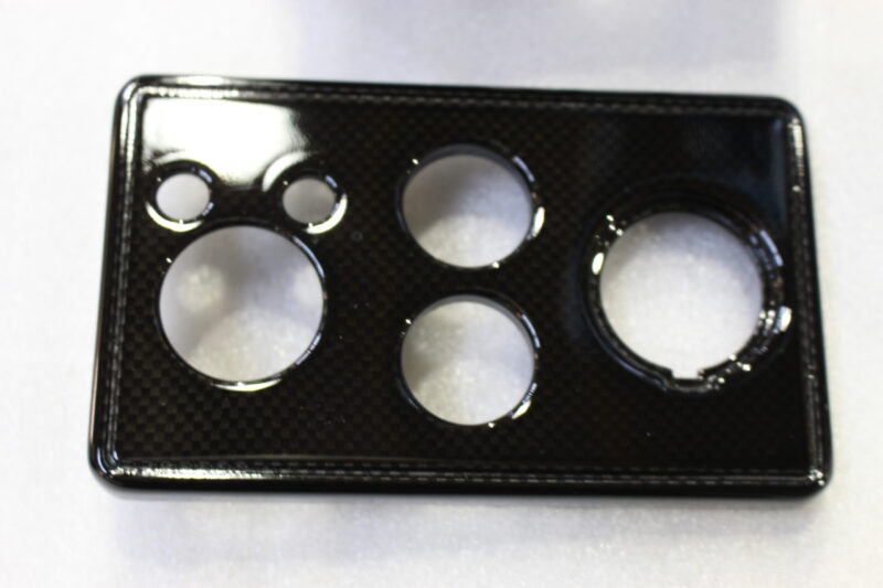 Parts of dashboard coated in carbon fibre