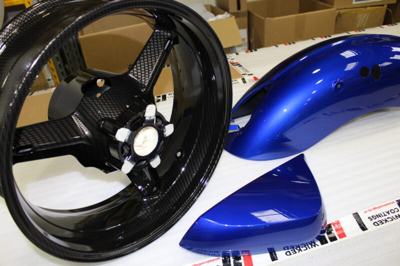 Motorbike parts coated in carbon fibre painted blue