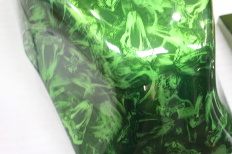 Motorbike tank coated in snakes painted green