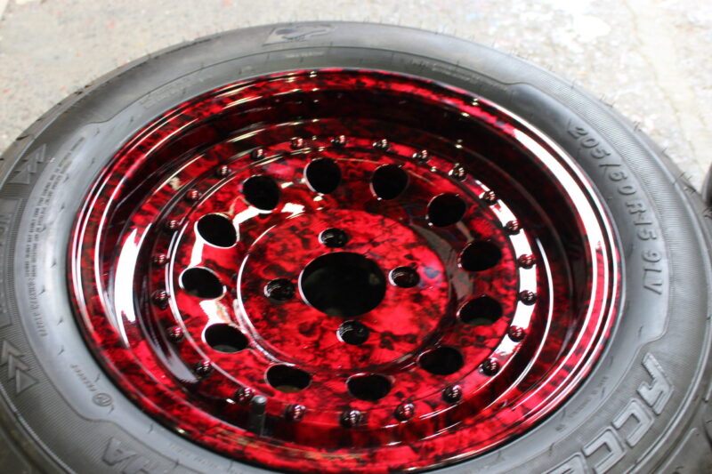 Car wheels coated in skull painted red