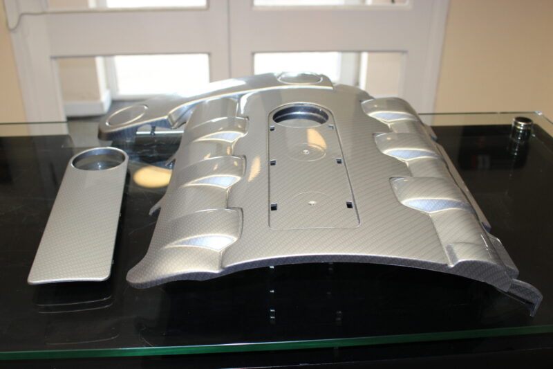Car engine element coated in carbon fibre painted silver